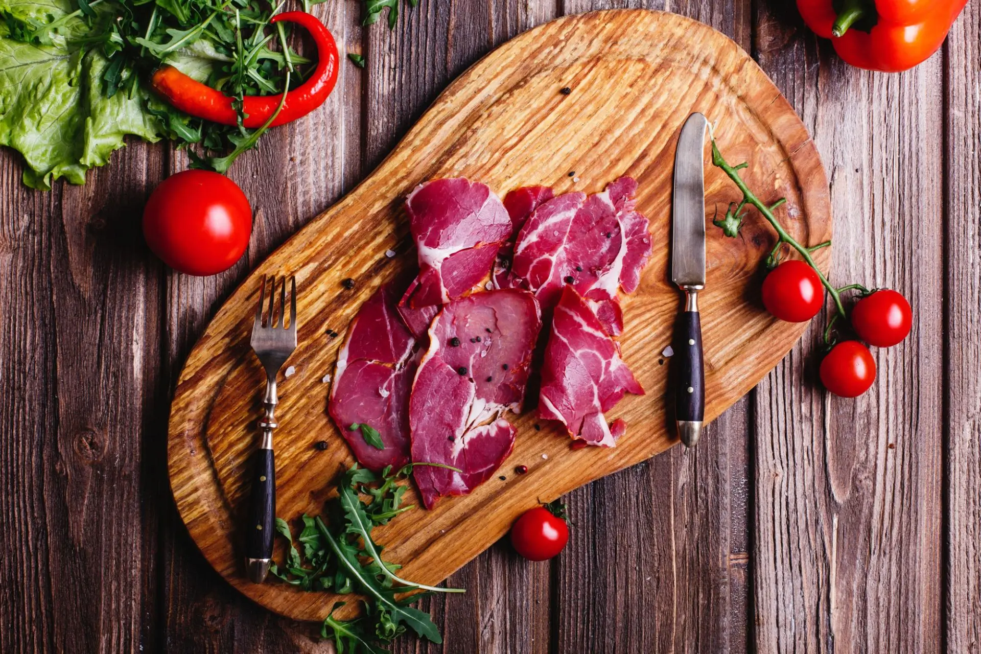 fresh-healthy-food-sliced-red-meat-lies-wooden-table-with-arugula